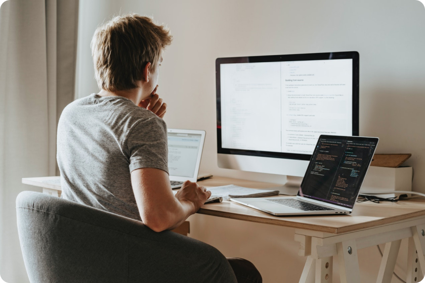 Man in front of a computer writing an article